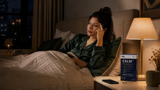 Tired woman unable to switch off at night with QIA Calm+ on the bedside table